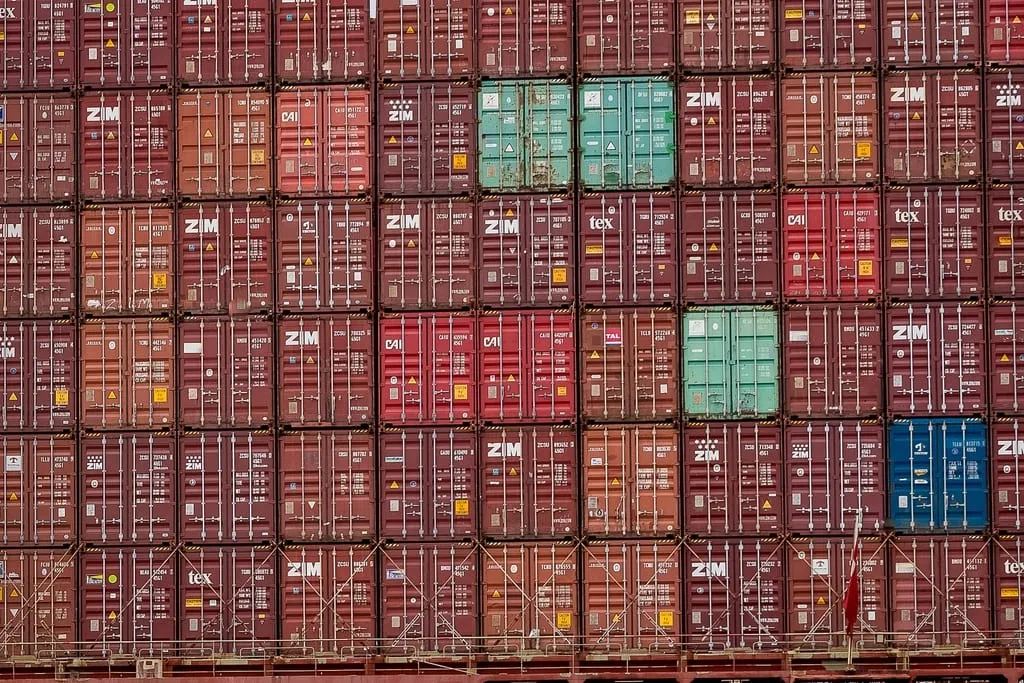 Shipping containers stacked many rows high on a vessel.
