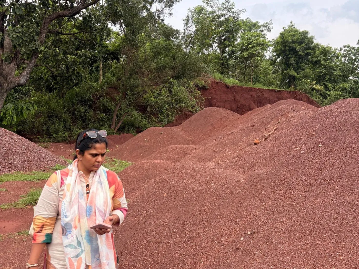 A Brikway colleague checking material at the foot of a graded stockpile.