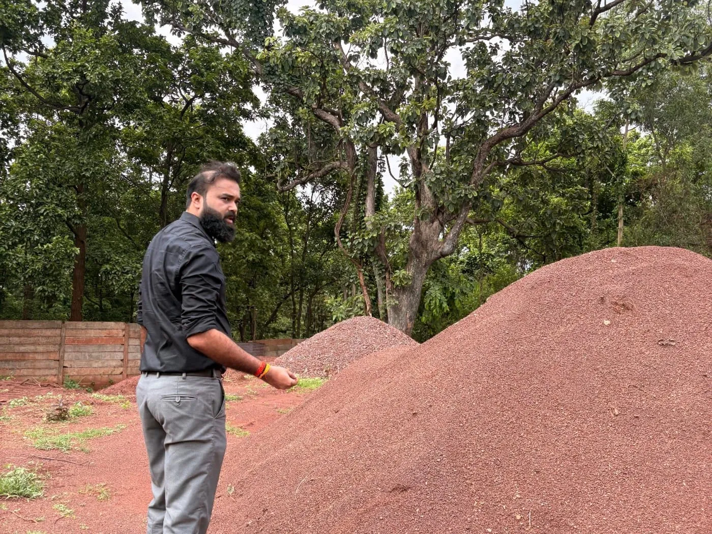 A Brikway colleague inspecting a graded ore stockpile at a sourcing site.